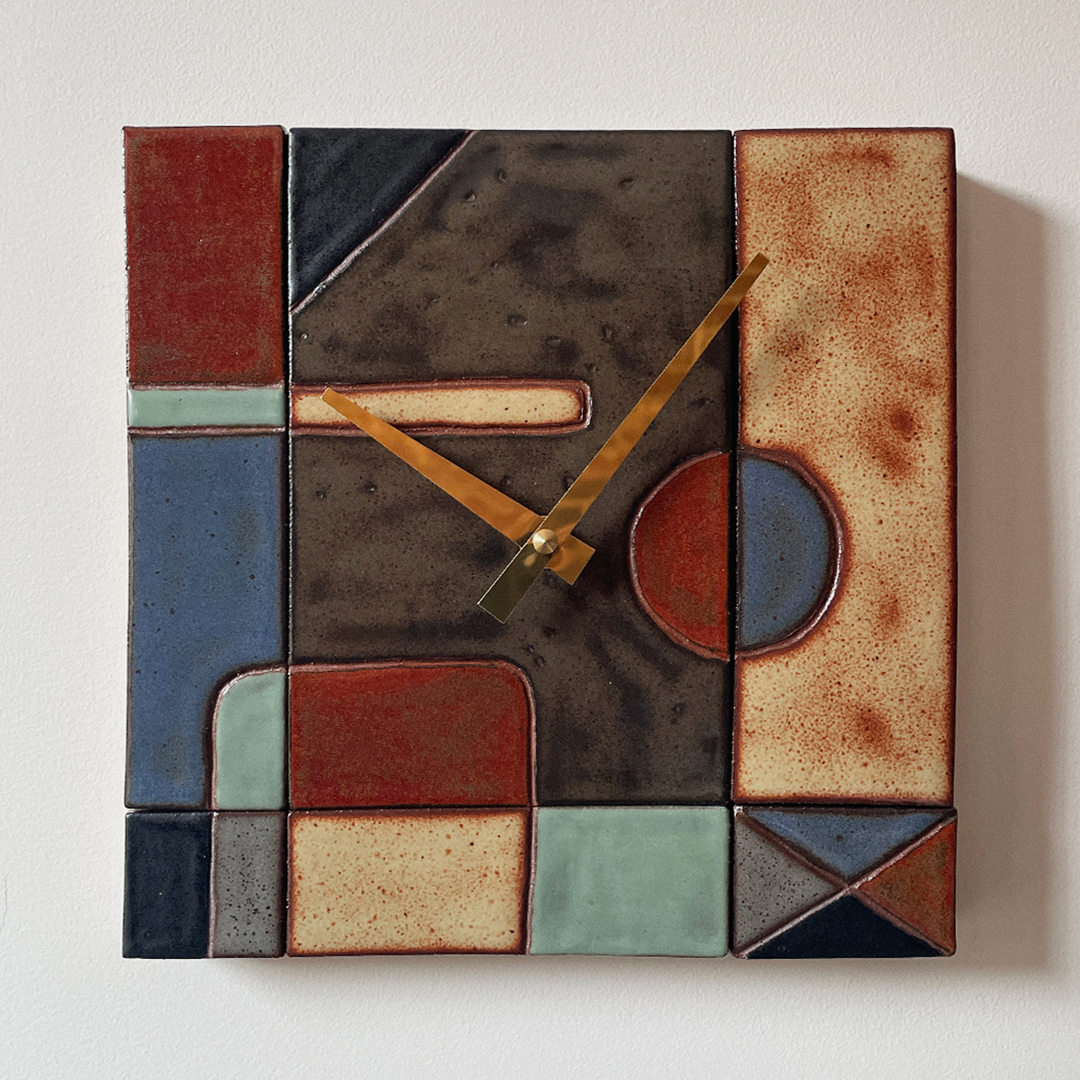 A square wall clock with an abstract mid-century modern geometric design, featuring a textured glaze in earthy tones of brown, terracotta, slate blue, sage green, and cream, with gold-toned hands.